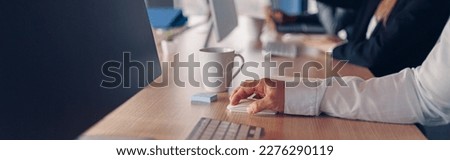 Close up of businessman hands on keyboard during working day in office