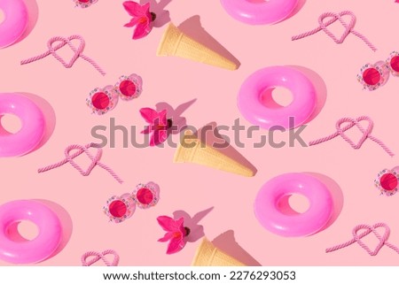Summer holiday creative concept, beach accessories, cute pattern pastel pink background. 