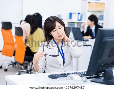 Businessperson Suffering from Stiff Shoulders Royalty-Free Stock Photo #2276297487