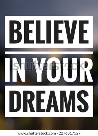 Motivational quote "Believe in your dreams" on blurred abstract background. Beautiful blurred night lights.