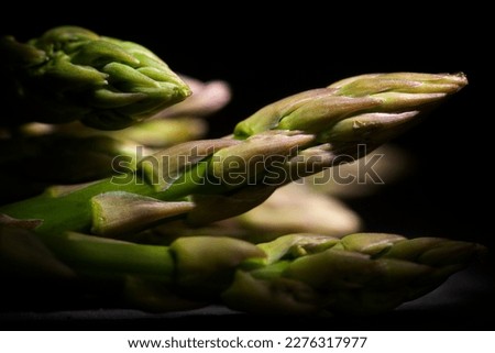 Close up in the shade of a bunch of wild asparagus. Royalty-Free Stock Photo #2276317977