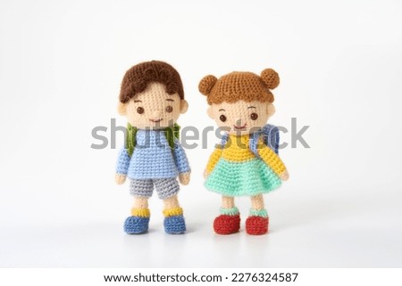 Small and cute Amigurumi doll on white background.　school