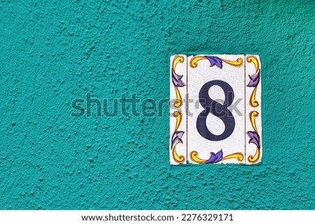 House Number 8: Address Marker on House Wall