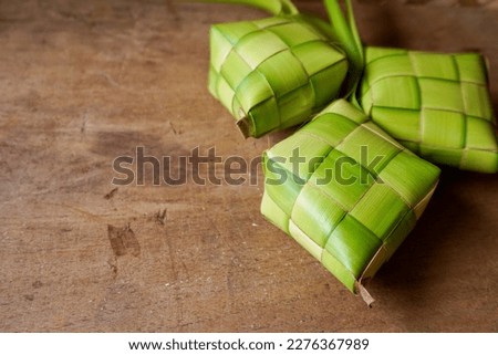 Close up view of Ketupat, an Indonesian traditional cuisine very popular during Hari Raya Idul Fitri. Ketupat is a natural rice casing made from young coconut leaves for cooking rice. Royalty-Free Stock Photo #2276367989