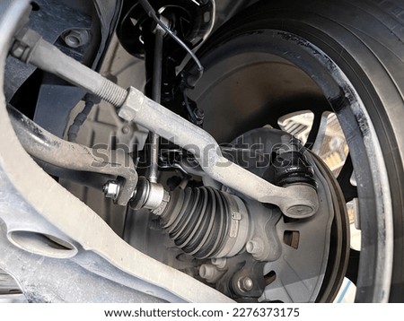 steering rack tie rod of right wheel is checked during the maintenance with inner and outer tie rod end, control coil springs , ball joint and rack pinion unit by machanic before going long trip Royalty-Free Stock Photo #2276373175