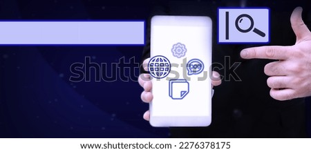 Man holding Mobile Phone Pointing to Screen Showing The Futuristic Technology. Businessman Presenting Cell Phone Inside Room Presenting Modern Automation.