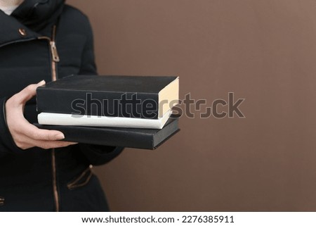 Books in the hands of a young girl