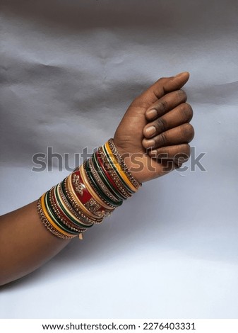 Lots of bangles in the hands of the bride.Lots of mix bangle in color color Royalty-Free Stock Photo #2276403331