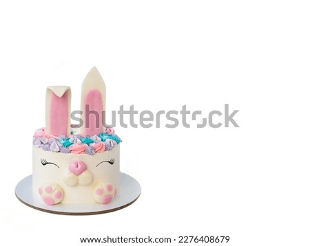 White and pink cake with cute bunny for children's birthday or Easter. Bunny made of fondant and buttercream. White background. Horizontal orientation