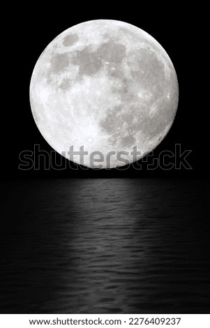 Moon at night in the black sky. The reflection of moonlight in the water Royalty-Free Stock Photo #2276409237