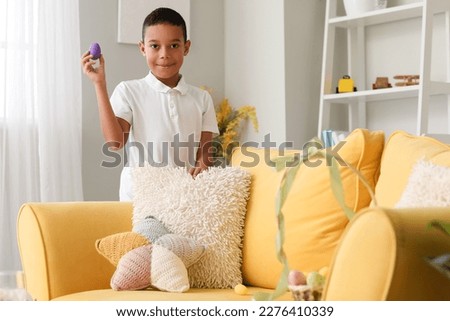 Little African-American boy with Easter egg at home