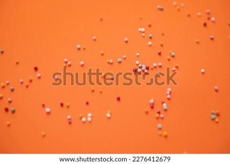 round confetti on orange background