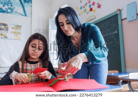 A teacher carries out educational activities with a pupil at school Royalty-Free Stock Photo #2276413279