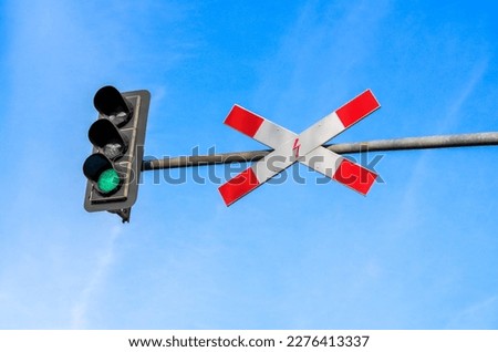 View of traffic light and sign against blue sky