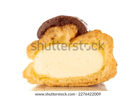 One half of a sweet chocolate eclair, close-up, isolated on a white background. Royalty-Free Stock Photo #2276422009