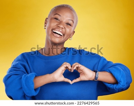 Heart hands, portrait and happy black woman in studio, background and color backdrop for emoji. Smile, female model and finger shape for love, thank you and support of peace, care or sign of kindness