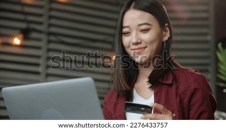 Asian young woman resting and browsing internet with Laptop holding credit card online shopping concept. Close up. Copy space