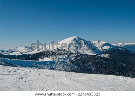 Snow-capped mountain on a clear sunny day