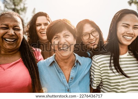 Happy multigenerational women with different ethnicity having fun smiling in front of camera in a public park - Females empowerment concept Royalty-Free Stock Photo #2276436717