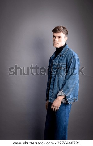 Young man with short hair clean shaven in jean jacket
