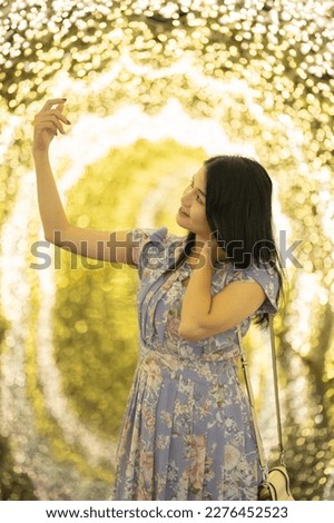 Portrait of happy Asian woman with bokeh blurry background for lighting festive celebration concept. illumination. People lifestyle.