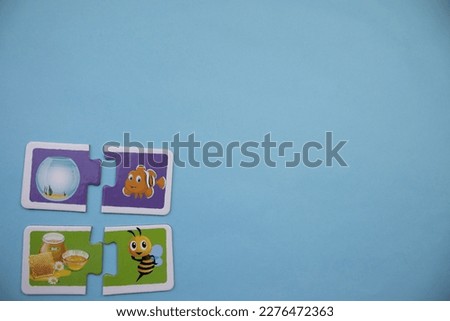 fish and bee picture puzzles, placed to the left of the blue background, lantern, honey, fish and bee picture puzzles