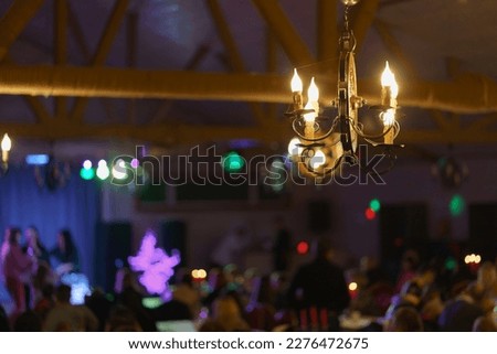 Defocused photography of night party. Bright various colors of lights. The magical atmosphere of the holiday. Weekend free time concept.