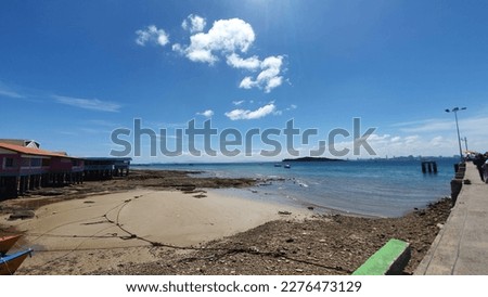 The picture of the bridge and the golden sand beach tell the blue sea.