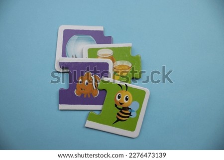 fish and bee picture puzzles, mixed on a blue background, bell jar, honey, fish and bee picture puzzles
