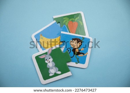 bunny and monkey picture puzzles, banana, carrot, rabbit and monkey picture puzzles mixed up on a blue background