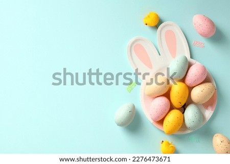 Easter rabbit shaped plate with colorful Easter eggs on blue background. Happy Easter greeting card template.