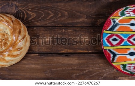 Rishtan Uzbek national plate and   journey cake bread on wooden background. Postcard for Navruz, Kurban bayram