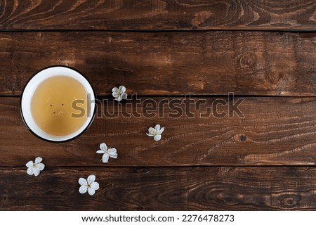teabowl with white cherry flowers on wooden background. Navruz, Ramadan postcard