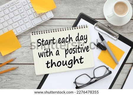 Start each day with a grateful heart. text on white paper near the keyboard and feminine stickers. light wooden background Royalty-Free Stock Photo #2276478355