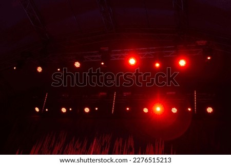 Red stage lights with smoke on concert. Background in show. Interior shined with a projector. entertainment lighting on stage. 