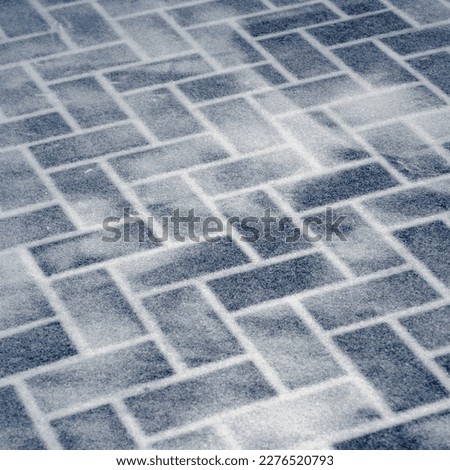 Unusual design of floor made of icy bricks. Minimal background with Simple texture of brick wall of transparent ice. Perspective of floor in cold winter palace. Minimalist backdrop of icy wall.