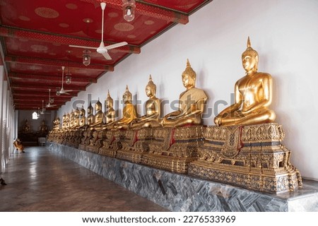 Golden Buddha statues in Wat Pho, Bangkok. Wat Pho is one of the oldest and largest temples in Bangkok features the famous Reclining Buddha Royalty-Free Stock Photo #2276533969