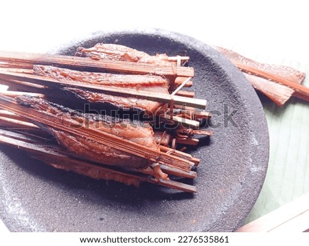 Smoked fish. Smoked stringry on mortar stone against white background. Fresh. Smoked stringray fillet of Fillet fish. Seafood. Isolate.  Royalty-Free Stock Photo #2276535861