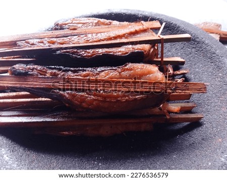 Close up of Smoked fish. Smoked stringry on mortar stone against white background. Fresh. Smoked stringray fillet of Fillet fish. Seafood. Isolate.  Royalty-Free Stock Photo #2276536579