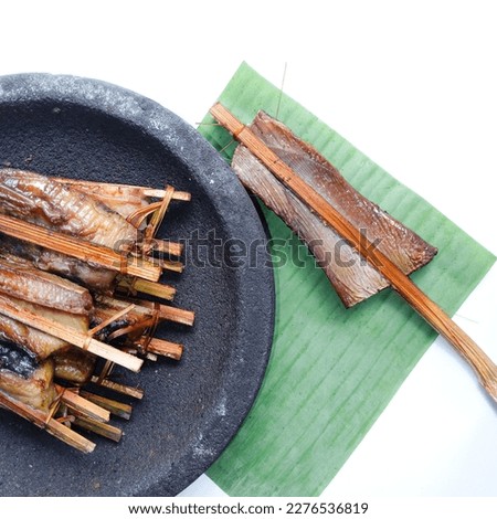 Top view of Smoked fish. Smoked stringry on mortar stone against white background. Fresh. Smoked stringray fillet of Fillet fish. Seafood. Isolate.  Royalty-Free Stock Photo #2276536819