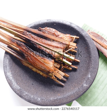 Smoked fish. Smoked stringry on mortar stone against white background. Fresh. Smoked stringray fillet of Fillet fish. Seafood. Isolate.  Royalty-Free Stock Photo #2276540117