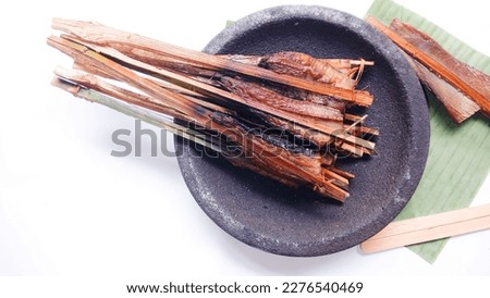 Top view of Smoked fish. Smoked stringray on mortar stone against white background. Fresh. Smoked stringray fillet of Fillet fish. Seafood. Isolate.  Royalty-Free Stock Photo #2276540469