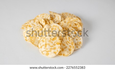 Piles of Tempeh Chips in Isolated Background Royalty-Free Stock Photo #2276552383