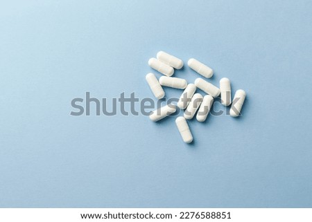 Leucine amino acid. Fitness supplement on paper background. Soft focus. Top view. Copy space. 