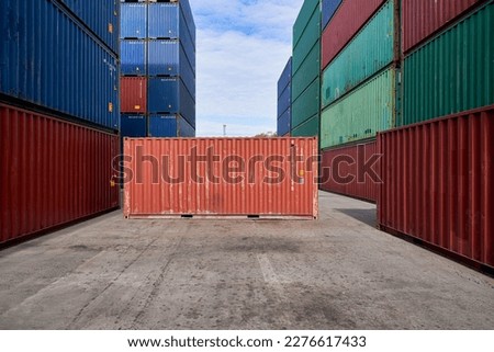 Orange container box stack on center of many container stacking in logistic service site for shipment item oversea. Royalty-Free Stock Photo #2276617433
