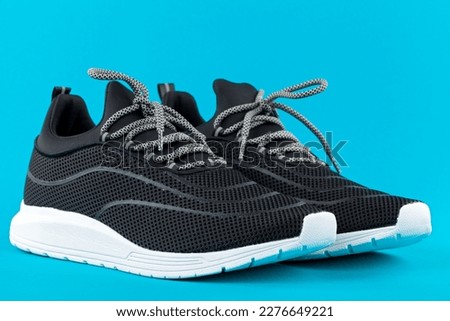 Close up picture of comfortable mens sneakers on grey background. New, fashionable, casual footwear