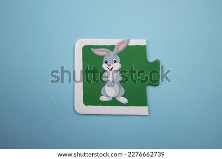 Rabbit picture puzzle, Rabbit picture puzzle placed on a blue background.