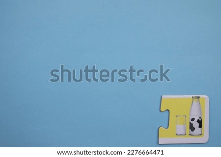 milk bottle picture jigsaw, milk bottle picture jigsaw placed on the right of a blue background.