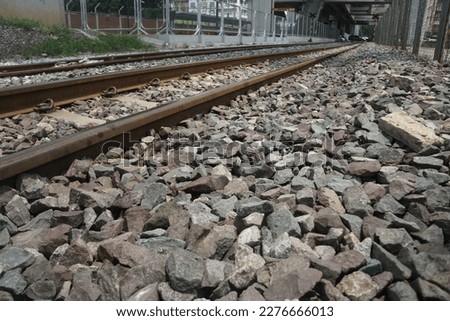 Railway Ballast rocks. Broken stone ballast, superior stone ballast is normally derived from rigid stones like granite, quartzite, and hard trap.  Royalty-Free Stock Photo #2276666013
