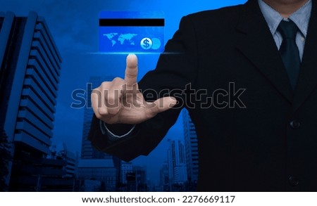 Businessman pressing credit card over modern office city tower and skyscraper, Online e-payment concept, Elements of this image furnished by NASA